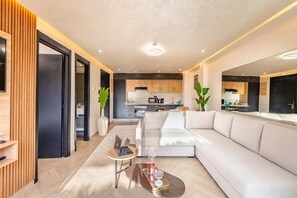 A modern living room with a sofa, a coffee table, and a laptop. - LUXURY APARTH GUELIZ MARRAKECH AYLAL  (Safi)