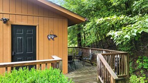 A wooden cabin with a black door, a small porch with chairs, and a sign that reads 'All you need is cozy cabin.' - Mountain Mist Cottage , Valley Views , Sleeps 6 (Sevierville)