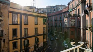 A street view with buildings, a curved road, and a clear sky. - CasaMaGà  (Naples)