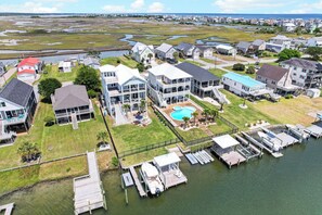 A residential area with houses, a swimming pool, and docks. - Canalfront dock, game room and elevator (Surf City)
