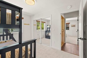 A room with a bed, a window, and a door leading to another room. - Tahoe State of Mind & Water Views (South Lake Tahoe)