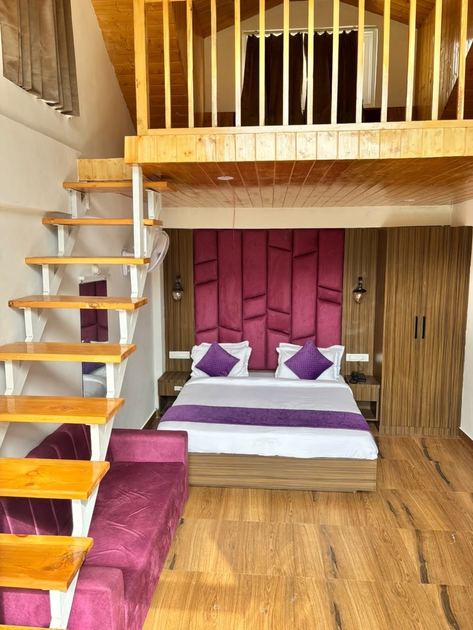 A bedroom with a wooden staircase, a bed with a headboard, and a wardrobe.