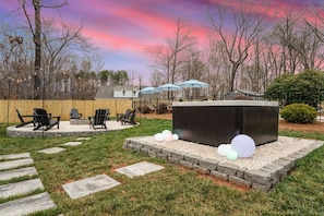 A backyard with a fire pit, outdoor seating, and a shed. - Greensboro Getaway Villa (Greensboro)