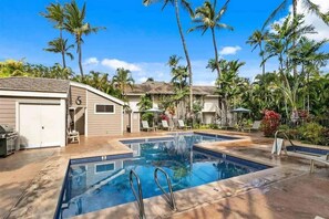A swimming pool with two diving boards, surrounded by palm trees and a covered seating area. - Spacious Ground Floor Maui Retreat, Grand Champion (Kihei)