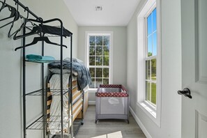A laundry room with a metal rack, a washing machine, and a drying area. - Renovated 6BR Near Grand Lake Fire Pit & Games (Grove)