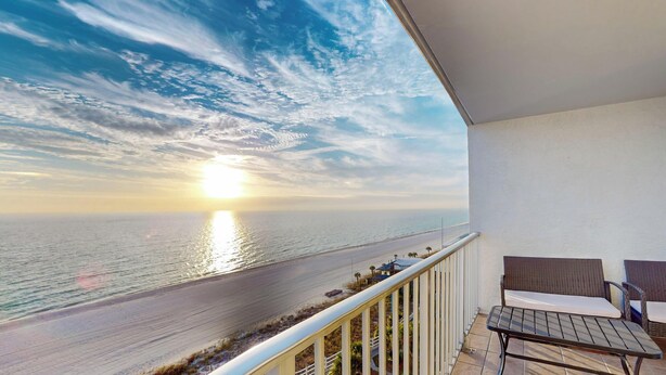 A balcony with a view of the ocean and a sunset. - Summit 1013 (Panama City Beach)