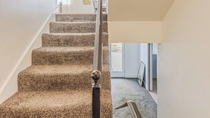 A carpeted staircase with a handrail, white walls, and a framed picture on the wall. - 72 S Orem Upstairs Only (Orem)