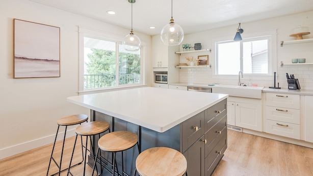A kitchen with a large island, bar stools, pendant lighting, and a view of the outdoors. - 72 S Orem Upstairs Only (Orem)