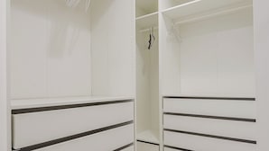 A modern, empty walk-in closet with white shelving and drawers. - 72 S Orem Upstairs Only (Orem)
