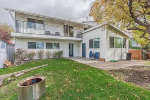 A two-story house with a front yard, a fire pit, and a small shed. - 72 S Orem Entire Home (Orem)