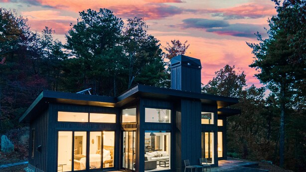 A modern cabin with large windows, a deck, and a chimney. - Ridge (Lenoir)