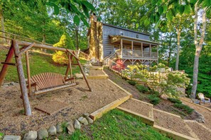 A wooden swing set, a stone pathway, and a house with a porch. - Appaljack Retreat (Blowing Rock)