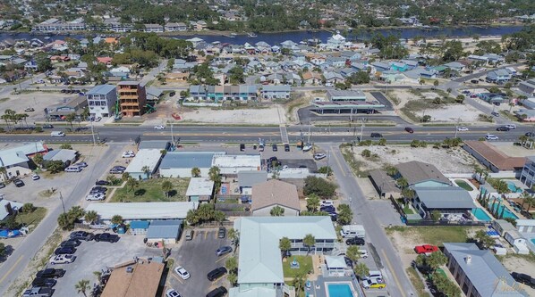 An aerial view of a coastal residential area with houses, a road, and a beach. - Sea Esta - Minutes to Beach Pet-friendly! (Panama City Beach)