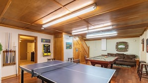 A room with a ping pong table, pool table, and a sofa. - Heavens Hideaway (Ferguson)