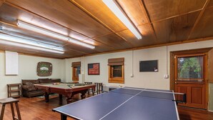 A room with a pool table, a ping pong table, a billiards table, and a billiards cue rack. - Heavens Hideaway (Ferguson)