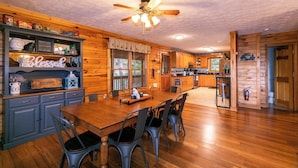A wooden interior with a dining table, chairs, and a ceiling fan. - Heavens Hideaway (Ferguson)