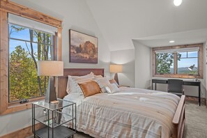 A bedroom with a large bed, a desk, and two windows. - Bull & Bear at Eagles Nest (Banner Elk)