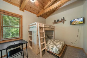 A bunk bed with a desk and chair, a TV, and a window with blinds. - Appalachian Satisfaction (Banner Elk)