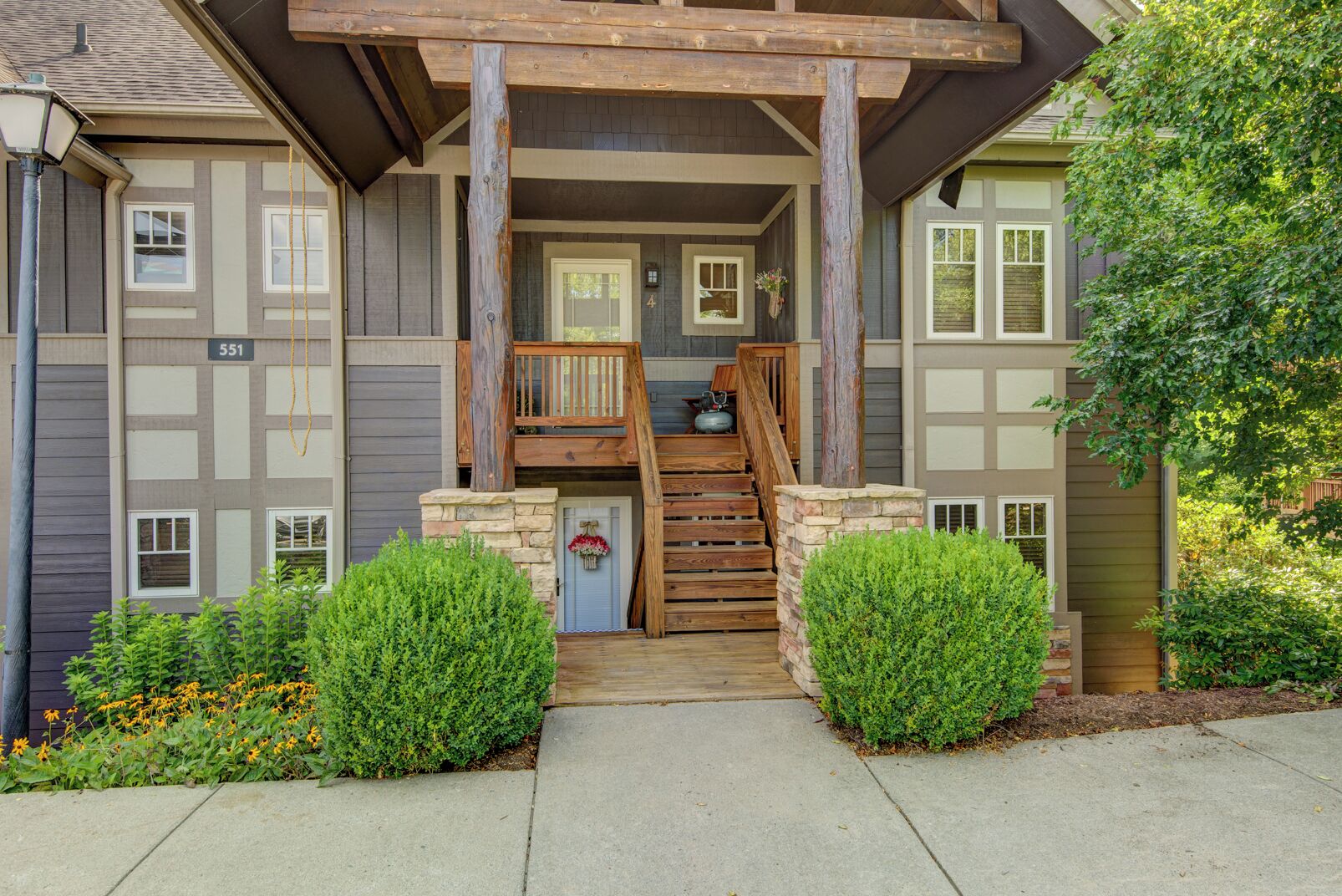 A two-story building with a wooden staircase leading to a porch.