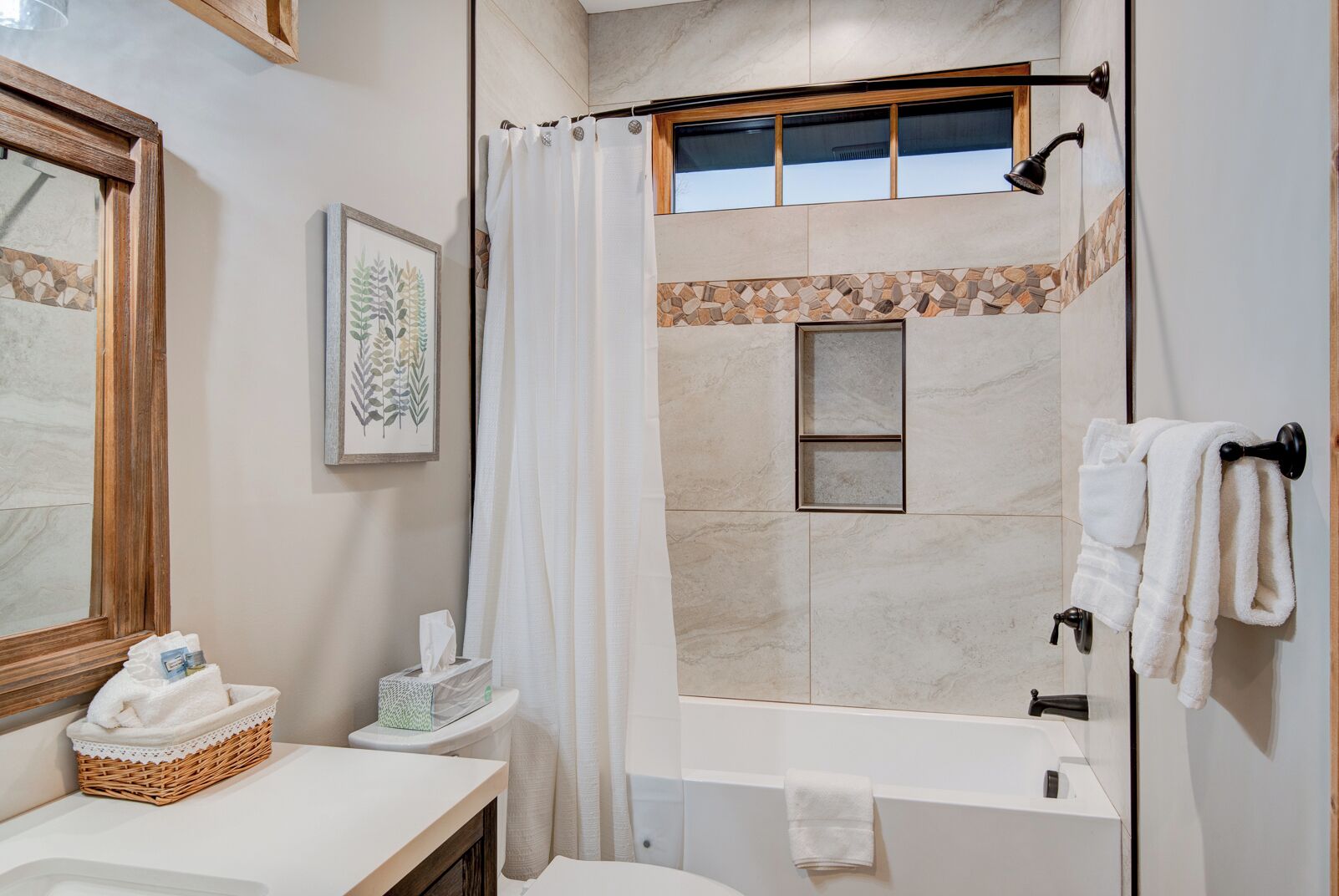 A modern bathroom with a shower, a bathtub, a sink, and a towel rack.
