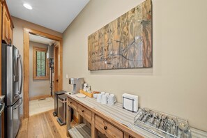 A kitchen with a stainless steel refrigerator, a coffee maker, and a wooden countertop. - River Rock (Banner Elk)