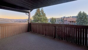A balcony with a view of a mountainous landscape and a tree. - 7035 Park City #3R (Park City)