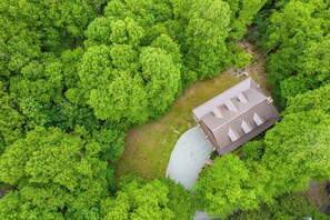 An aerial view of a house surrounded by dense green forest. - Hebron Falls Cabin (Boone)