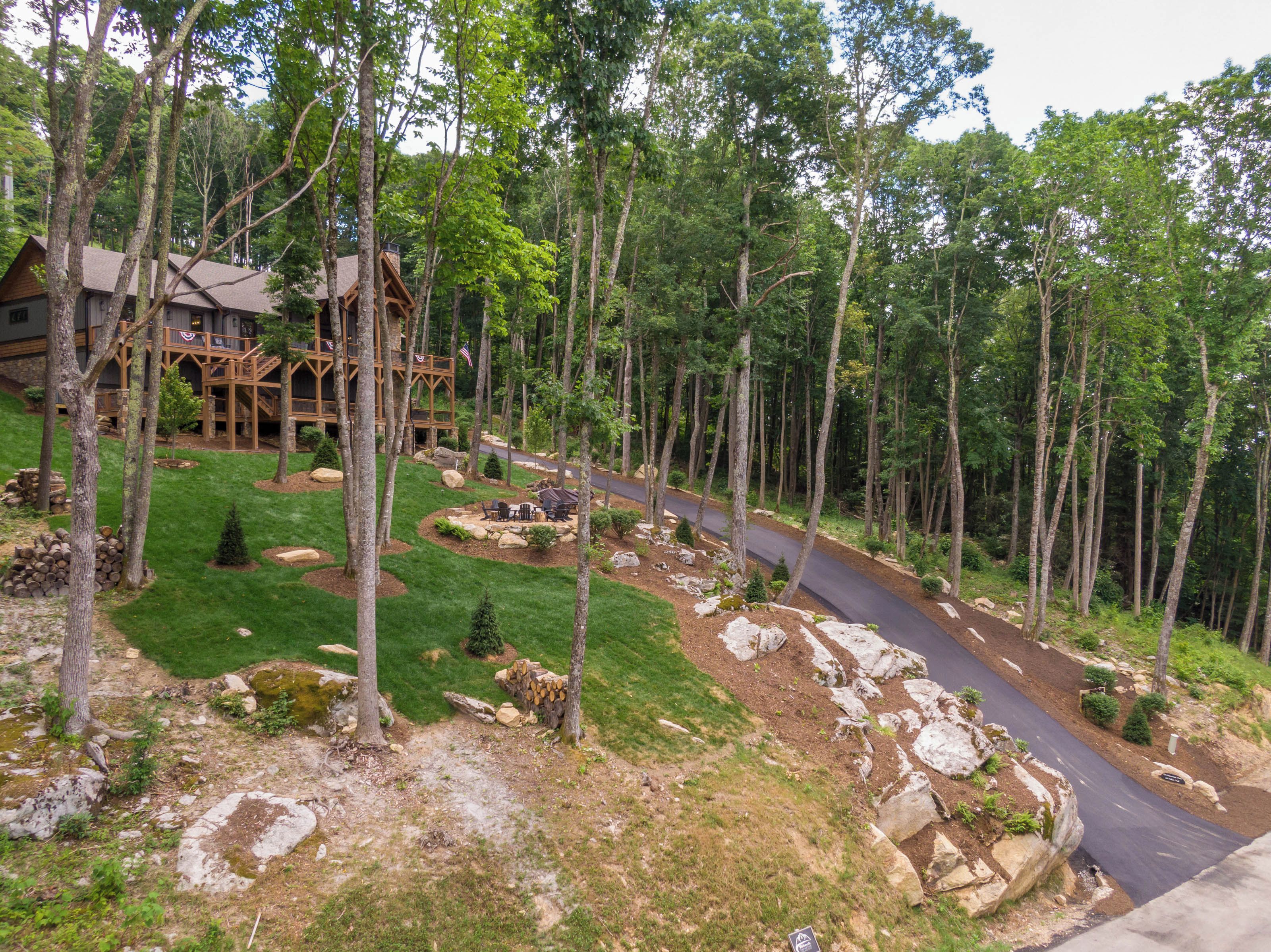 A lodge with a wooden deck and a stone pathway leading to a guest area.