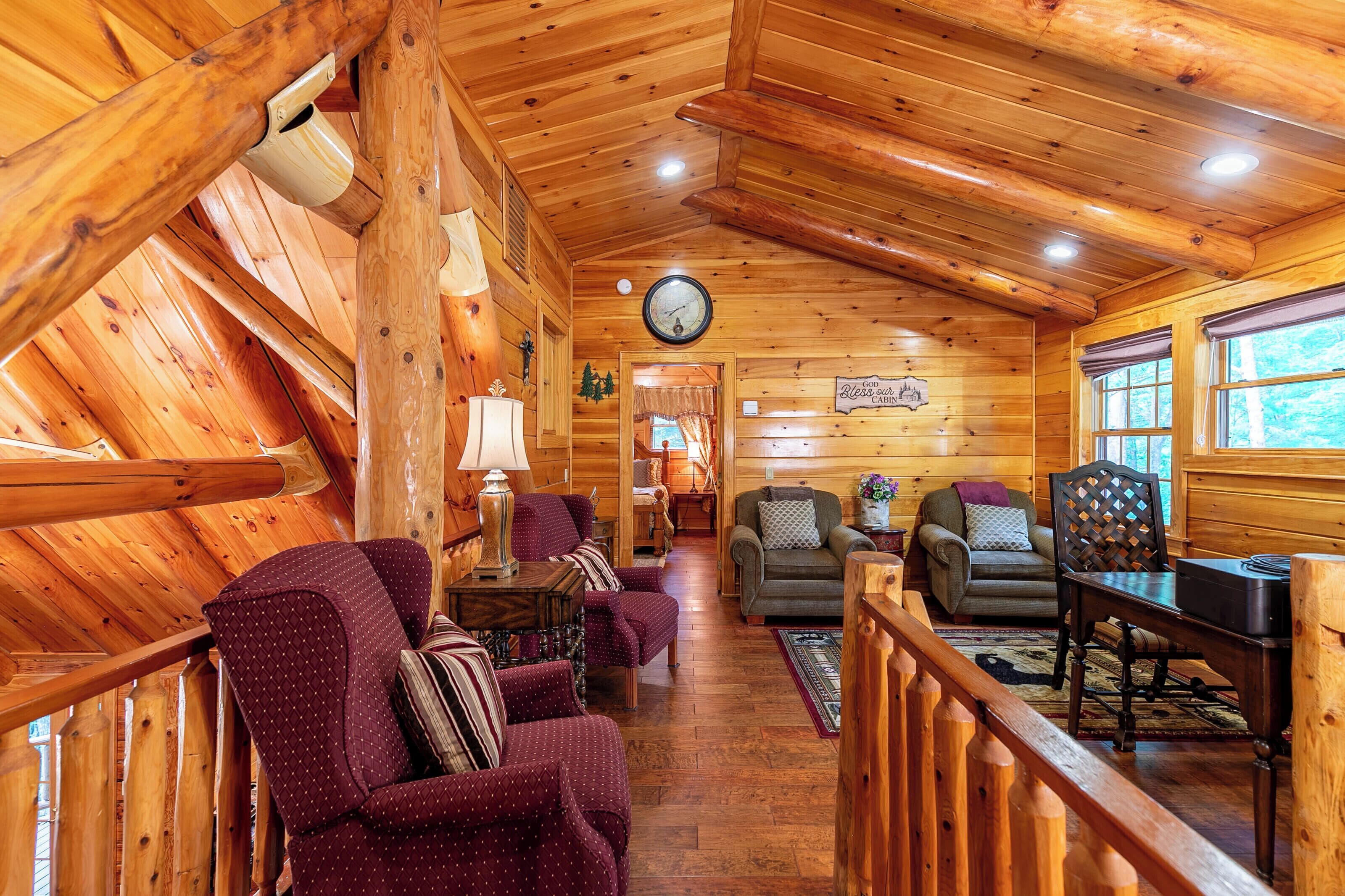 A cozy cabin interior with wooden walls, a wooden ceiling, a clock, and a sign reading "Cabin's Bliss."