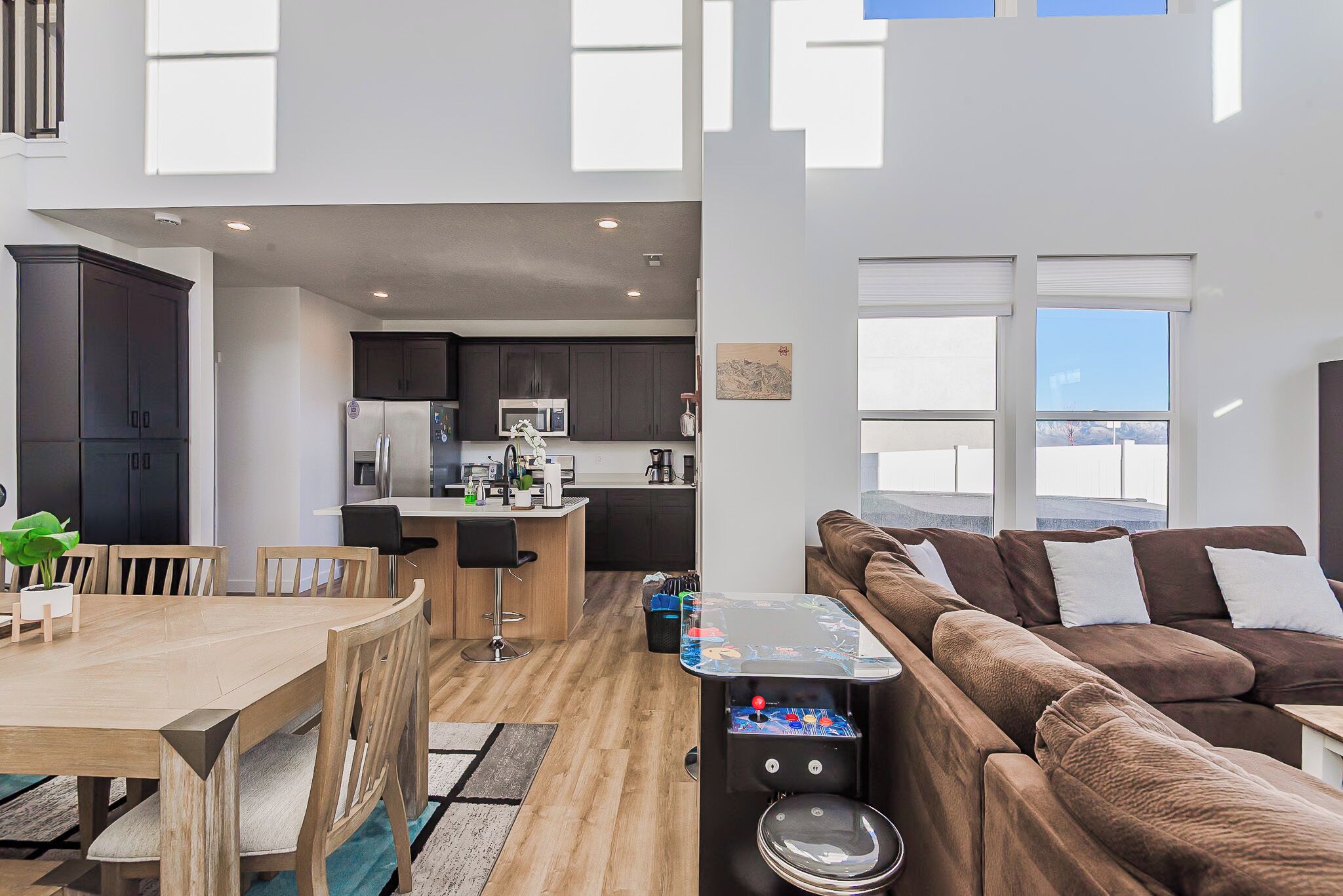 A modern apartment with a kitchen, dining area, and living room.