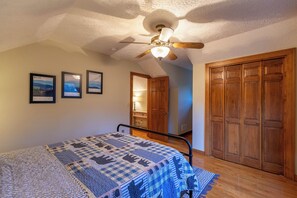 A bedroom with a bed, wooden wardrobe, and a ceiling fan. - Nuttin' Better (Blowing Rock)