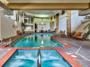 An indoor swimming pool with a hot tub, lounge chairs, and a tiled floor. - Shores of Panama 2026 (Panama City Beach)