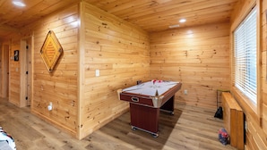 A wooden-floored room with a pool table and a dartboard. - Chasing Clouds Cabin (Fleetwood)