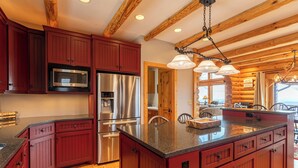 A kitchen with wooden cabinets, stainless steel appliances, and a granite countertop. - Good Day Sunshine (Lenoir)