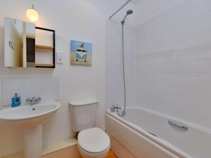 A bathroom with a sink, toilet, and bathtub. - Village Home With Sea Views (Truro)