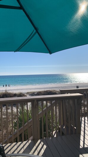 A wooden deck with a view of the beach and ocean. - Beachside townhome on the beach  (Panama City Beach)