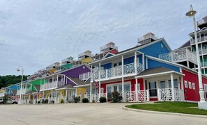 A row of colorful, multi-story buildings with balconies, likely a hotel or resort. - Spacious 3-bedroom apartment in beautiful Branson with AC and gym (Branson)