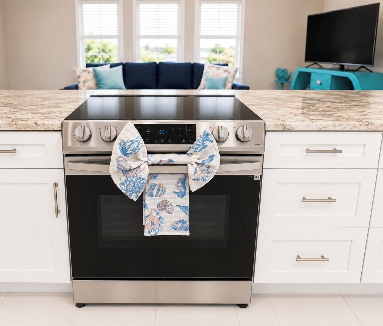 A kitchen with a stainless steel oven, a digital clock, and a patterned towel tied around the oven door.