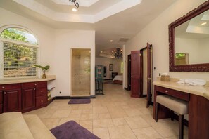 A spacious bathroom with a large mirror, a shower, and a vanity with a sink. - Harmon House 6 BR with private pool (Playa Herradura)
