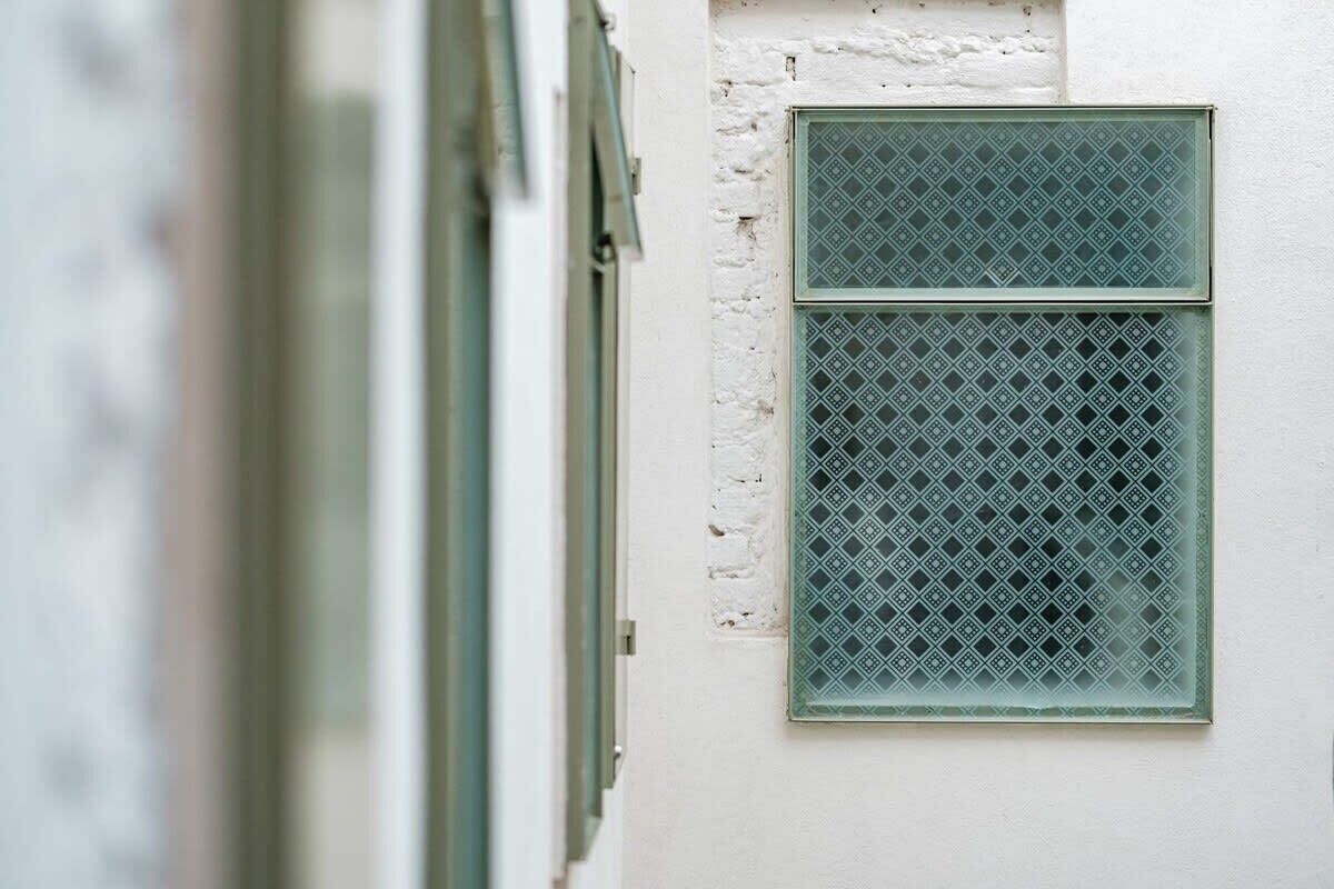 A window with a diamond-patterned grille.