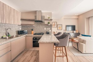 A modern kitchen with granite countertops, stainless steel appliances, and a central island. - Regatta Living Ii with Breakfast Included! - 406 (Santo Domingo)