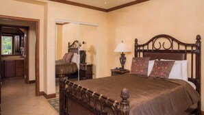 A bedroom with a large bed, a nightstand, a lamp, and a mirror. - Bay Residence 7C -  3 bdr 2 bath (Playa Herradura)