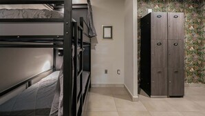 A bunk bed room with a wardrobe and a framed picture on the wall. - Shared Room Men / Low bed (Ciudad de México)