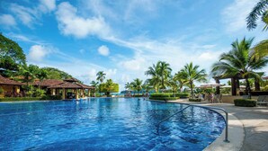 A large outdoor swimming pool with a clear blue sky, palm trees, and a gazebo. - Bella Vista 2D 3 bdr 3 1 and half bath (Playa Herradura)