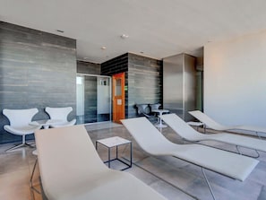 A modern spa area with lounge chairs, a reception desk, and a glass partition. - 1 Bedroom with balcony in Palermo Hollywood (Buenos Aires)
