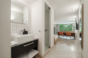 A modern bathroom with a white sink, mirror, and tiled backsplash. - Modern Loft with Balcony & View of Parque Mexico (Ciudad de México)