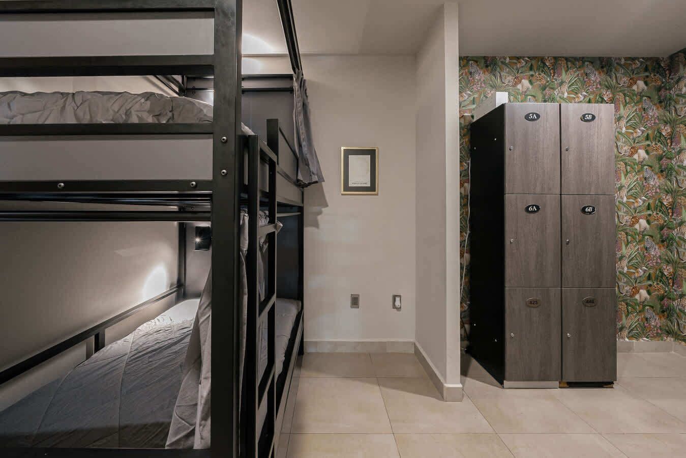 A bunk bed room with a wardrobe and a framed picture on the wall.