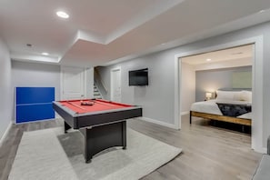 A modern room with a pool table, a bed, and a TV. - Hot Tub Modern Home Great Location (Arvada)