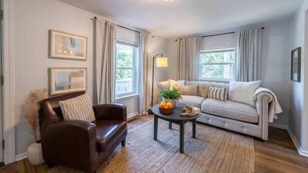 A living room with a sofa, armchair, coffee table, and a lamp. - Downtown Bungalow < Less than 1.5 Miles to UGA! (Athens)