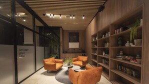Een modern interieur met een zithoek, boekenkasten en een houten plafond.